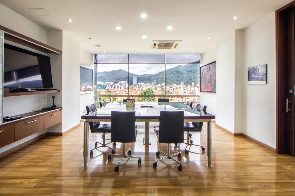 Spacious meeting room featuring contemporary design and city skyline view.
